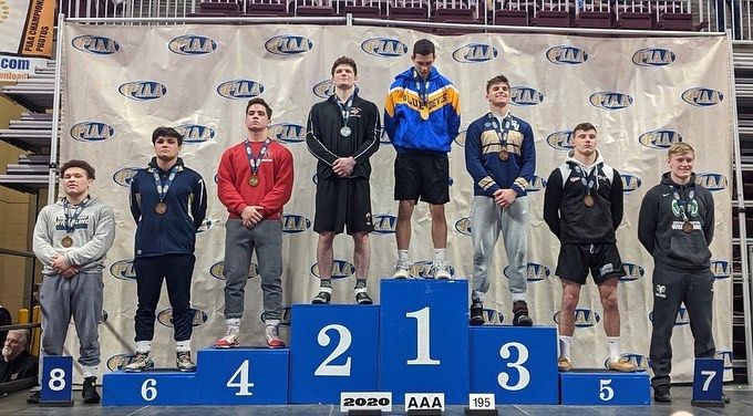 Louie standing in 8th place on the 2020 PIAA wrestling podium